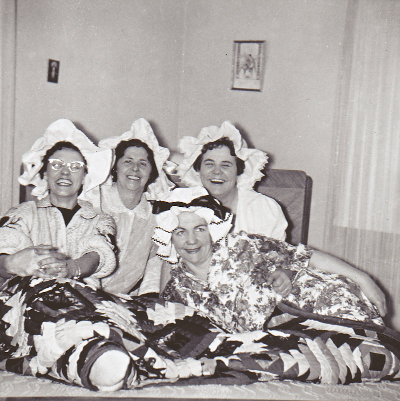 Ladies in baby hats in bed Copy